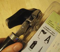 a person holding a pair of scissors in front of a label that says use a can opener to open blister packs and avoid cutting yourself