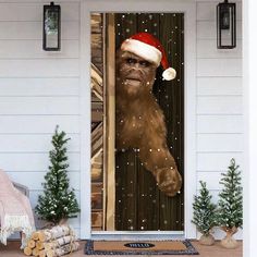 a door decorated with a christmas ornament and an image of a bigfoot wearing a santa hat