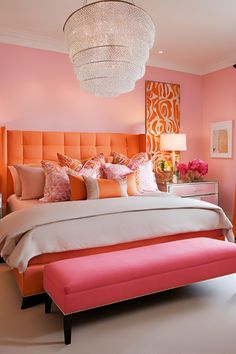 a pink and orange bedroom with a large bed