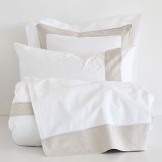 two white pillows sitting next to each other