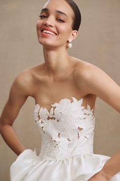 a woman in a white wedding dress smiling