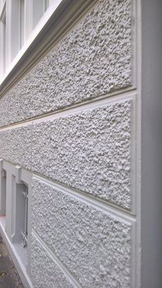 the side of a building with white stucco on it