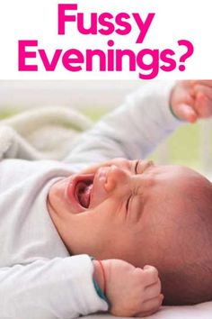 a baby laying on top of a bed with the caption fussy evening?