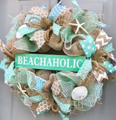 a wreath with the word beachaholic on it is hanging from a front door