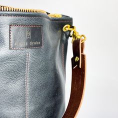 Our most popular mid-size design, this handbag screams style. With a zippered closure, midpoint size, four interior pockets and a hobo handle, we have much love for this beauty. Dimensions: 13” x 14” x 4 Features: -4 large interior pockets -zippered closure -hobo shoulder strap -add an optional crossbody strap Mid Size, Shoulder Tote, Crossbody Strap, Drake, Rocky, Bucket Bag, Most Popular, Shoulder Strap, Turquoise