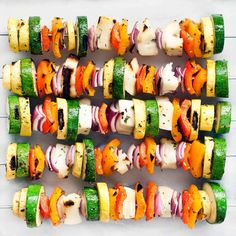 several skewered veggies are arranged on top of each other in rows