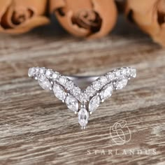 a diamond ring sitting on top of a wooden table