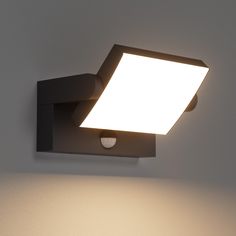 a light that is on the side of a wall with a white light in it