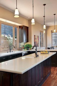 a large kitchen with an island in the middle and lots of counter space on one side