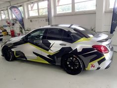 a car painted with black, yellow and white designs