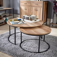 two coffee tables sitting on top of a rug