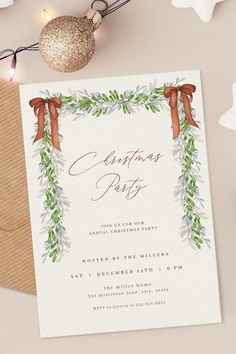 an elegant christmas party card with red bows and greenery on the front is displayed next to a gold ornament