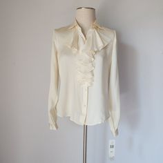 Lauren Ralph Lauren 100% Silk Satin Ruffle Blouse Long Sleeve Button-Up Cream New With Tag. Please Note *The Real Color Of The Item May Be Slightly Different From The Pictures Shown On Website Caused By Many Factors. *Don't Go By Size Number. Do Check Measurements To Determine If The Item Will Fit. Measurements; Approximately (Laying Flat). Shoulder To Shoulder: 15 Inches (Shoulder Seam To Shoulder Seam) Sleeve Length: 24 Inches (Shoulder Seam To Cuff) Armpit To Armpit: 20 Inches (Chest Measurem Elegant Ruffled Button-up Shirt, Formal Ruffled Button-up Shirt, Classic Formal Shirt With Ruffles, Elegant Button-up Ruffled Tops, Elegant Button-up Tops With Ruffles, Elegant Ruffled Button-up Tops, Classic Cream Blouse With Ruffled Collar, Formal Ruffled Button-up Top, Cream Ruffled Top For Formal Occasions