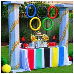 an olympic themed dessert table in the backyard