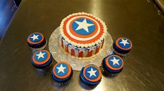 an image of a birthday cake with cupcakes on the table