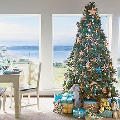 a living room with a christmas tree in the middle and presents on the floor next to it