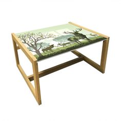 an animal themed coffee table with deer and trees painted on the top, sitting in front of a white background