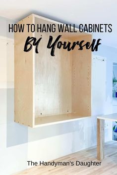 an unfinished cabinet with the words how to hang wall cabinets by yourself