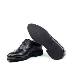 Also known as a wingtip, the Full Brogue is easily identifiable as one of the most classic pairs of men's dress shoes on the market. Featuring a brogue pattern along the sides as well as the toe cap, every man needs a Full Brogue in his shoe closet. Sole units (different available) are Blake stitched to uppers. Upper Materials: Black Box Calf Lining: Black Calf Leather Sole: Black Heeled Rubber Sole Last: Zurigo - Rounded Toe for Traditional English Look YOUR Package Includes Leather shoe cleani Jodhpur Boots, Men's Dress Shoes, Wood Shoes, Wingtip Oxford, Traditional English, Leather Box, Shoe Tree, Shoe Closet, Every Man