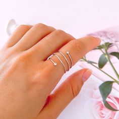 This beautiful spiral ring wraps around your finger. It has two small cubic zirconias at both ends of the wire to add a modern and elegant touch to your movements. It is made of genuine 925 Sterling Silver, it is also available in Gold plated over Sterling Silver. This open ring is perfect for any occasion. 👉🏼Details: ♥ Material: High-Quality Solid 925 Sterling Silver. ♥ Finish: Silver and Gold plated. ♥ Hypoallergenic: nickel-free and lead-free. 📏 Size: ♥ 6 US // 52 European ♥ 7 US // 54 Eur Adjustable Spiral Midi Rings In Minimalist Style, Wired Ring, Coil Ring, Spiral Ring, Swirl Ring, Thumb Ring, Ring Minimalist, Thumb Rings, Ring Dainty