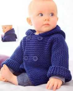 a baby wearing a blue knitted sweater with buttons