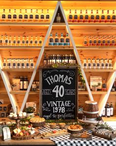 a display in a store filled with lots of bottles and pies on top of wooden shelves