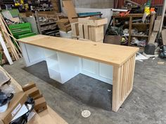 a wooden desk sitting in a room filled with boxes