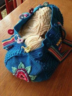 a crocheted purse sitting on top of a wooden table