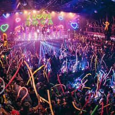 a large group of people standing on top of a stage surrounded by confetti