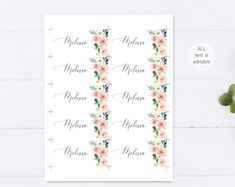 the floral name stickers are shown on top of a white table with succulents