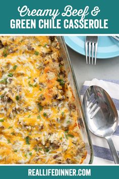 a casserole dish with cheese, green onions and ground beef in it on a blue plate