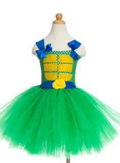 a green and yellow dress on a mannequin headdress with blue bows