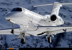 an airplane is flying over the snow covered mountains