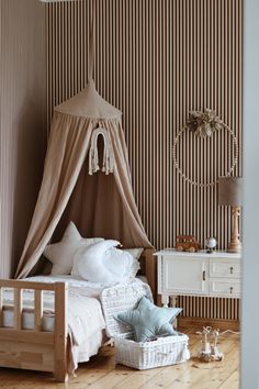 a bedroom with a bed, dresser and canopy