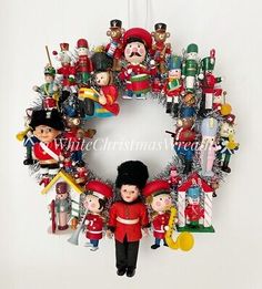 a christmas wreath with toys hanging from the front and back sides, all in different colors