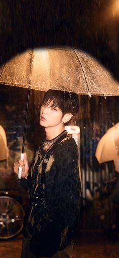 a woman holding an umbrella in the rain