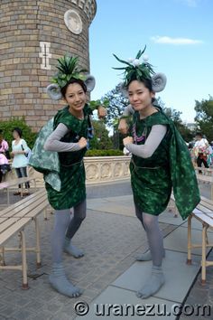 two women dressed in green costumes standing next to each other