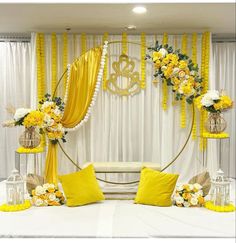 a yellow and white wedding setup with flowers