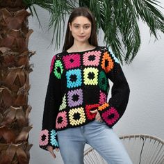 Introducing the Black Granny Square Cotton Sweater - a unique and stylish addition to your wardrobe! This sweater is a beautiful blend of different techniques, including knit cotton patchwork, crochet afghan, and boho-style design. Made from high-quality black cotton yarn, this sweater is durable, comfortable, and perfect for all seasons. The patchwork design features a variety of colorful crochet granny squares, expertly joined together with black yarn for a stunning contrast. This one-of-a-kin Black Patchwork Crew Neck Sweater, Black Crew Neck Sweater With Patchwork, Black Patchwork Cardigan For Winter, Black Patchwork Cardigan For Fall, Fall Black Cardigan With Patchwork, Winter Black Patchwork Cardigan, Black Patchwork Sweater For Spring, Black Knit Color Block Sweater, Black Color Block Knit Sweater