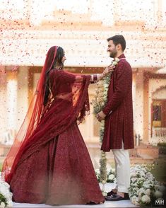 a man and woman dressed in red standing next to each other