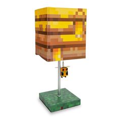 a lamp made out of lego blocks on a stand with a yellow and brown shade