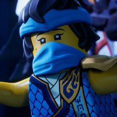 a lego man wearing a blue bandana and holding his arms out to the side