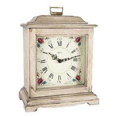 an old white clock with red roses on the face and numbers is shown in front of a white background