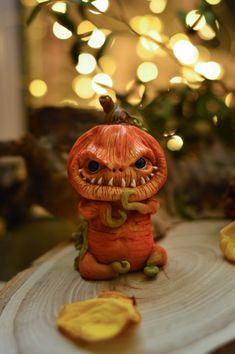 a small pumpkin statue sitting on top of a wooden table