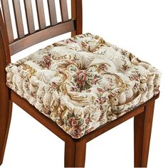 a close up of a chair cushion on a wooden chair with a floral print seat pad