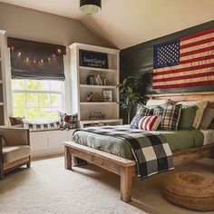 a bed room with a neatly made bed and an american flag on the wall