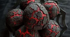 some black and red cookies in a metal bowl