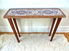 a wooden table sitting on top of a white rug