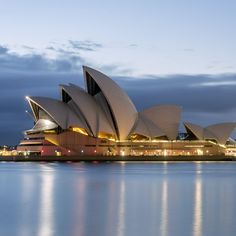 the sydney opera house lit up at night