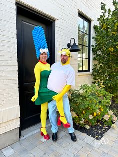 two people in costumes are standing next to each other